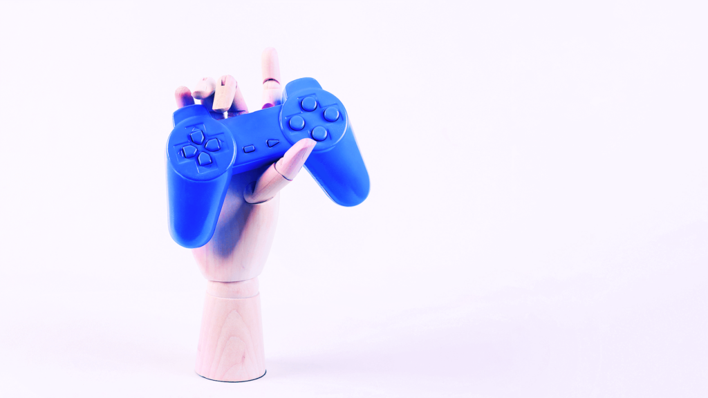 Concept image of hand grabbing a blue joystick.